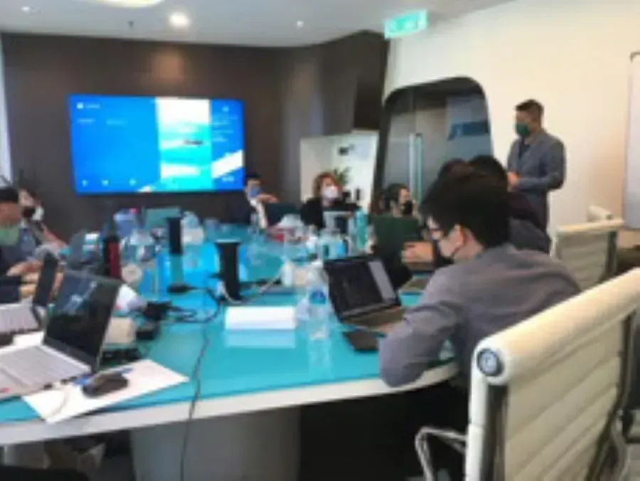 Modern corporate meeting highlighting collaboration and discussion of key strategies supported by DoerHRM's HR management system.